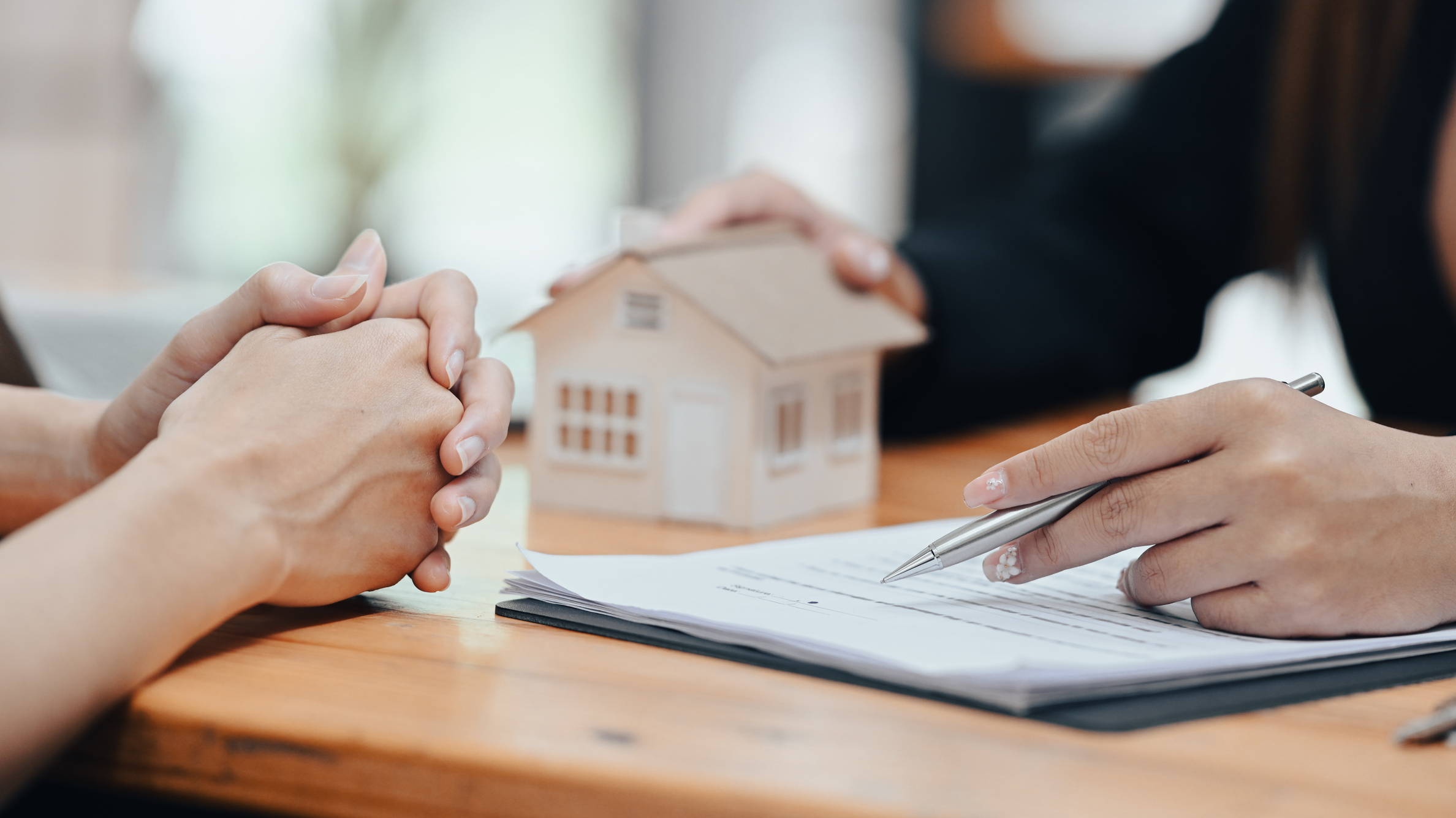 Real estate agent or financial advisor consulting with clien