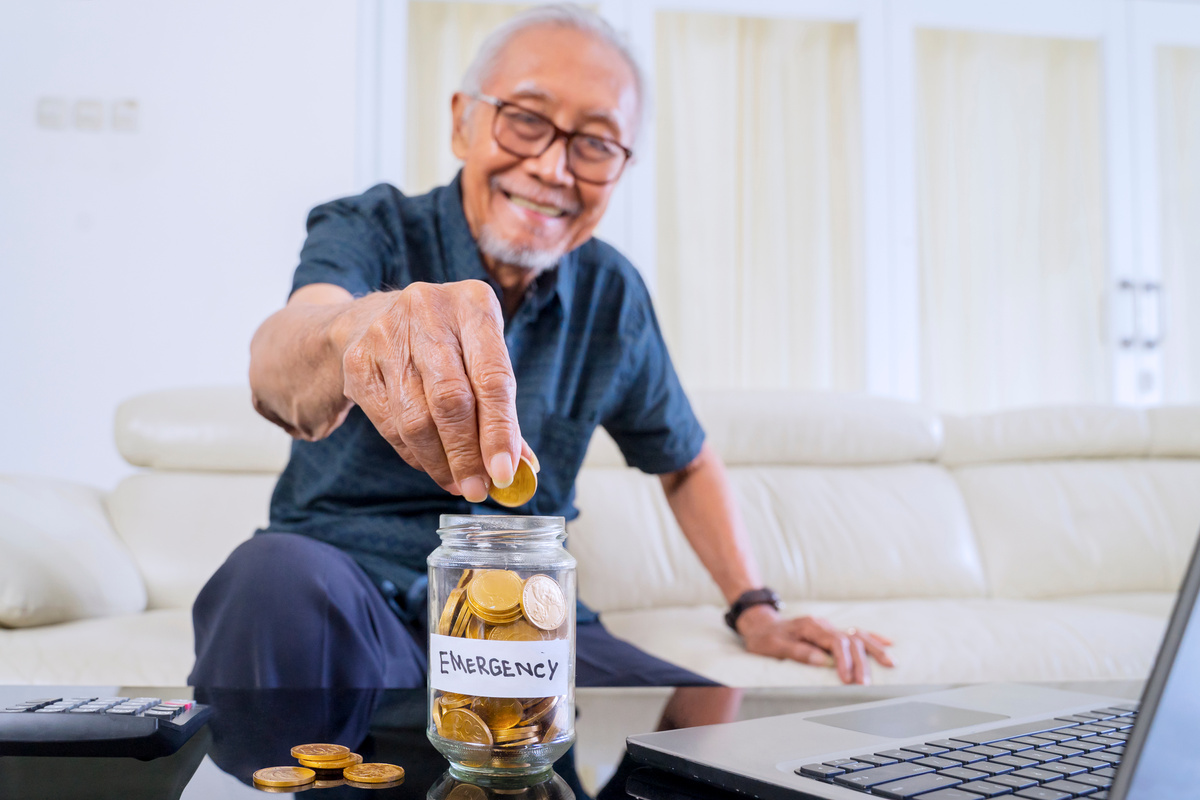 Old Man Savings Coins in Jar with Retirement Text